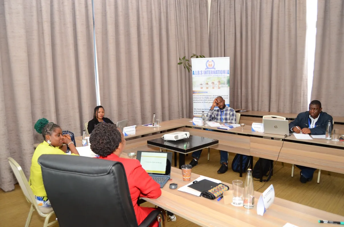 Participants seated in a U-shaped layout during an AIBS training session